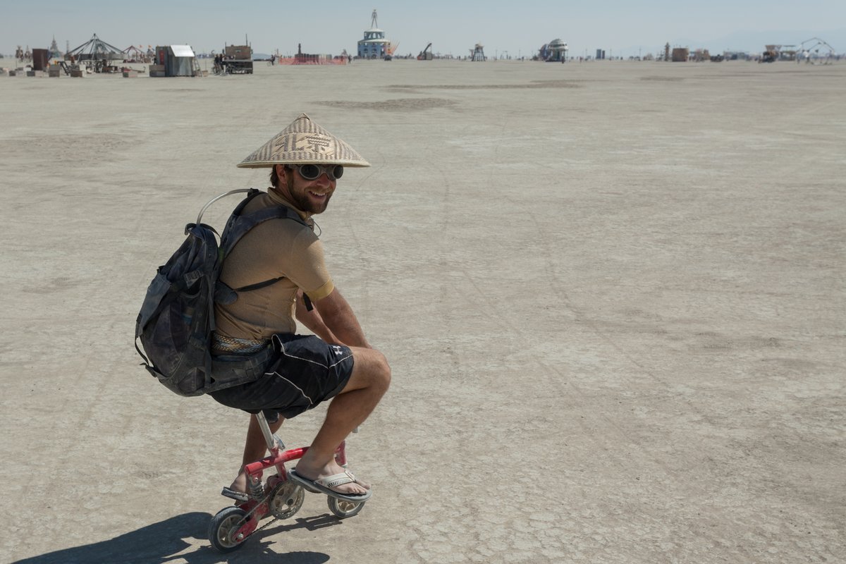 Ridiculously small bike guy is always smiling.