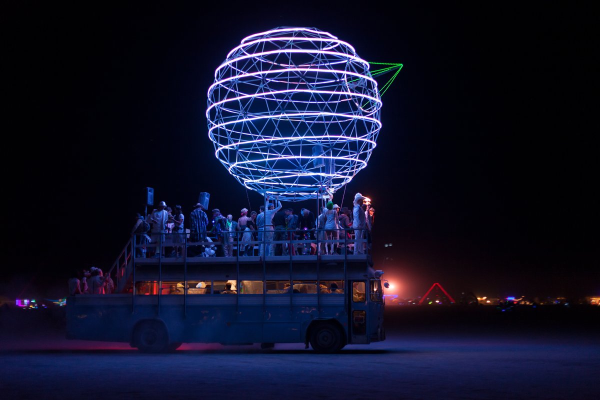 Death Star art car destroying stars on the Playa at night.