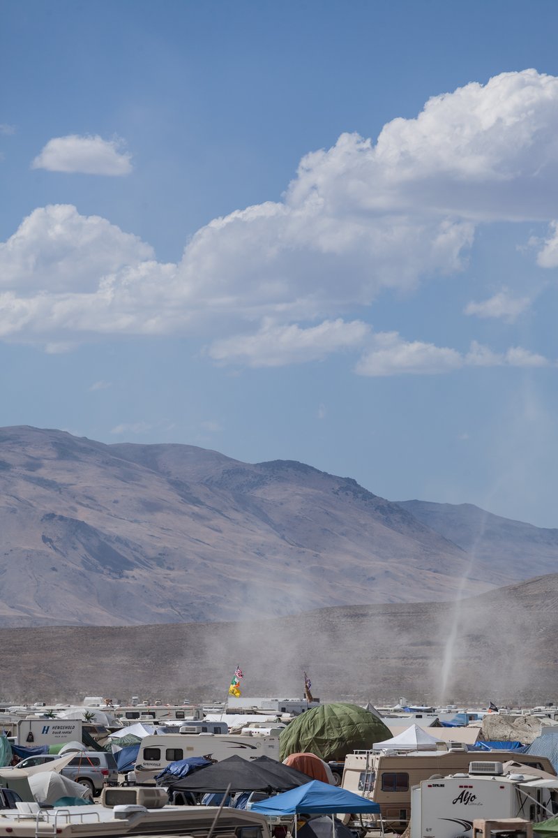 Small dust devil and the surrounding mountains.