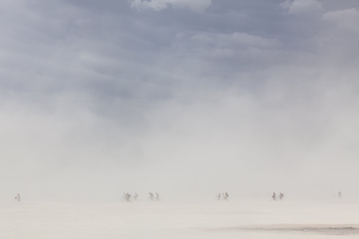 Tiny cyclists on the edge of a dust cloud on the Playa.