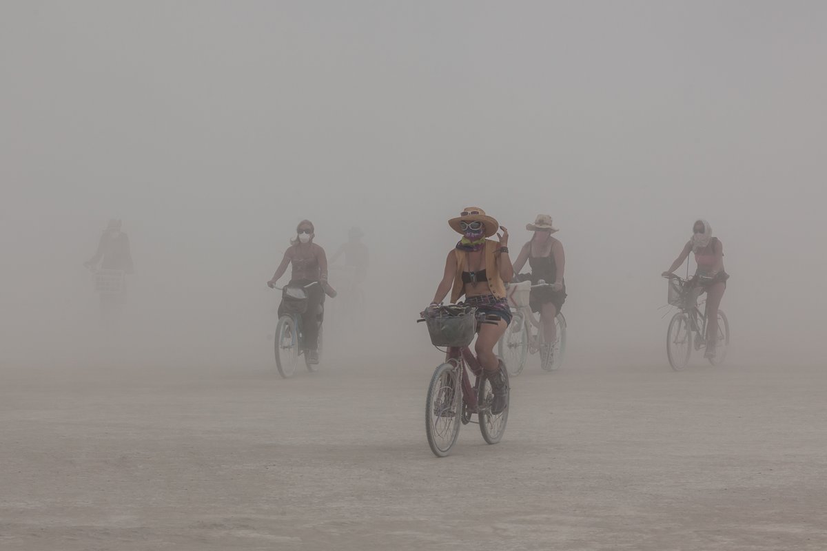 Cycling Burners emerge from the dust storm.