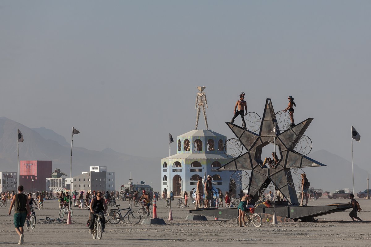 Burners interact with the art on the Playa.