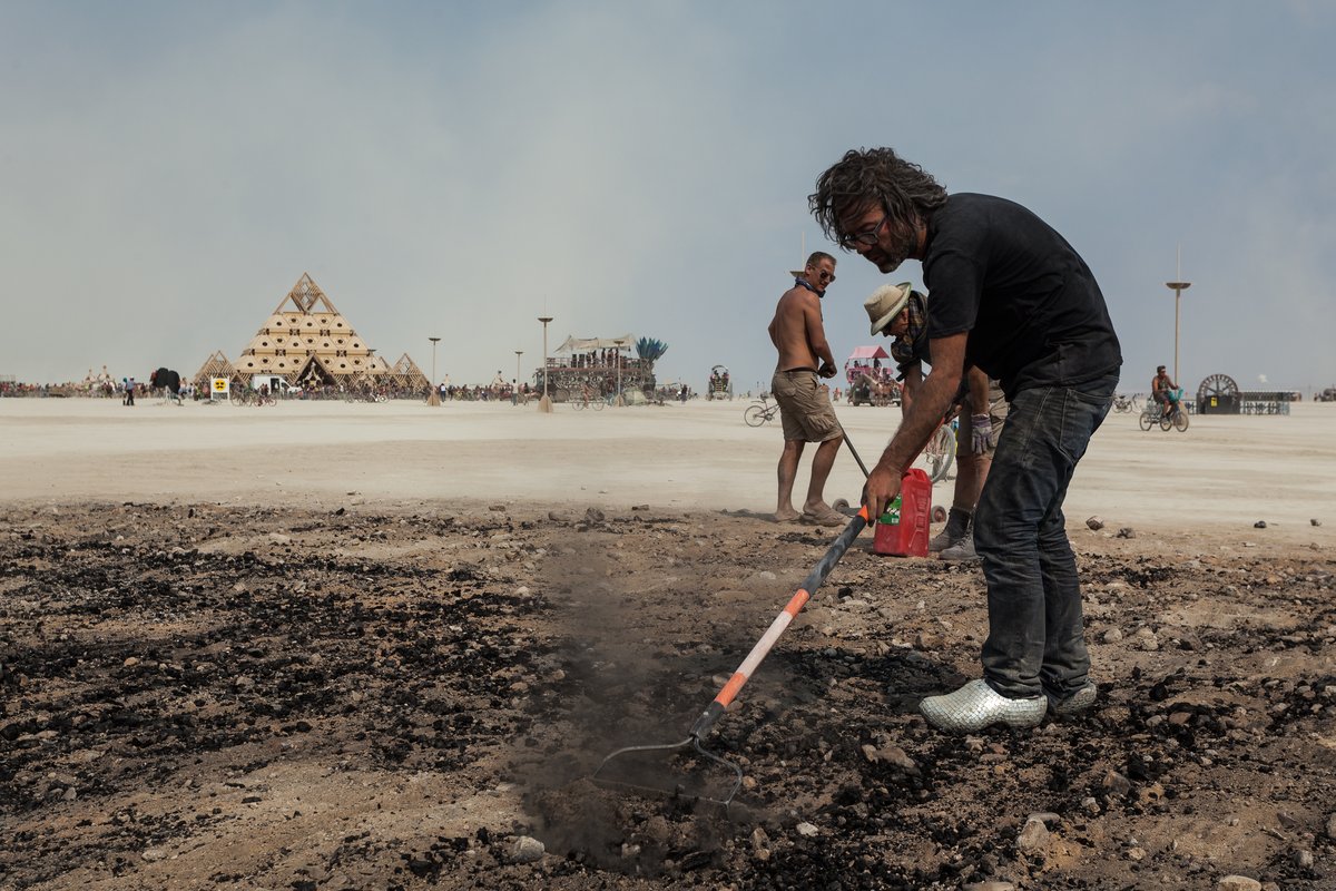 Artist Dadara cleans up after the giant Like burn.