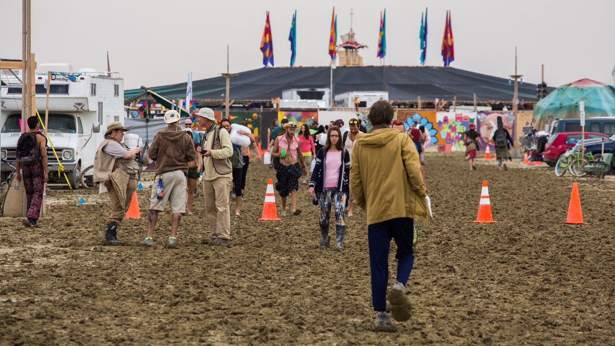 Folks Walking Down A Very Mucky 6