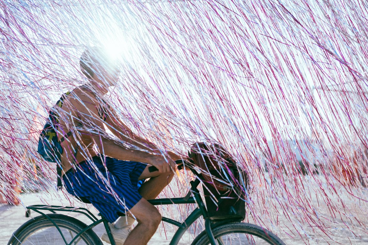 Burner Riding His Bike Through Tassles?/Fringe/Tinsle? What Do You Call This Stuff