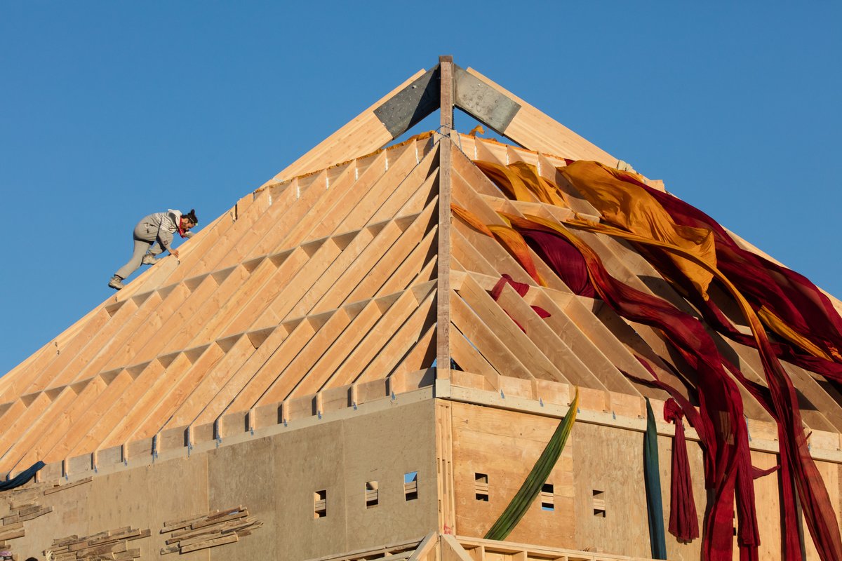 A Burner Climbs on The Catacomb of Veils by Dan Sullivan and the Catacomb Crew at Sunrise
