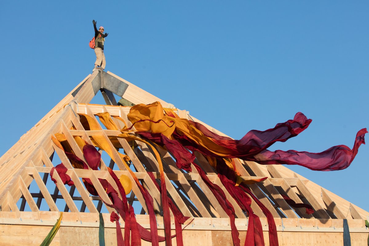 A Burner Climbs To The Top Of The Catacomb of Veils by Dan Sullivan and the Catacomb Crew at Sunrise