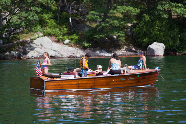 Family On A Wooden Boat