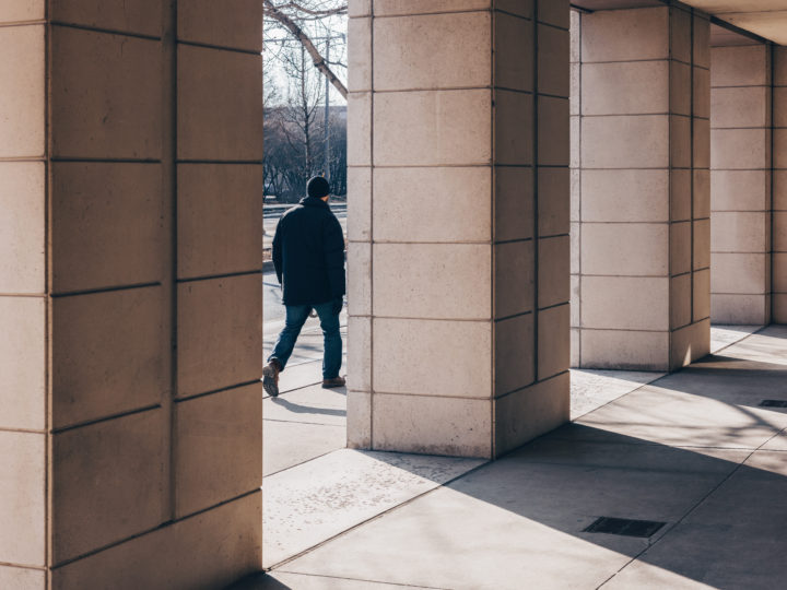 Man Walking And Columns