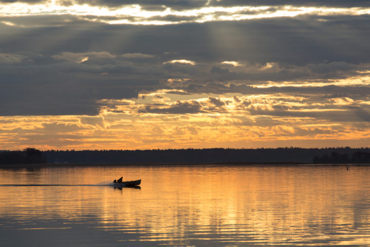 Small Boat At Sunrise