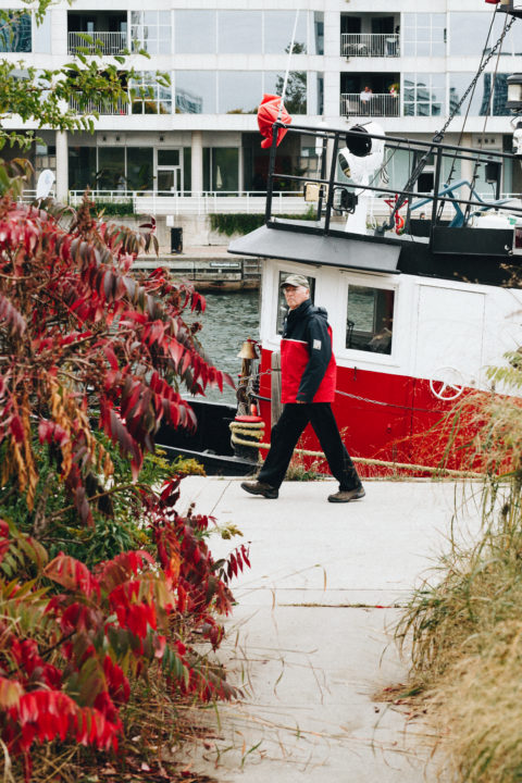 Man Walking And Tugboat