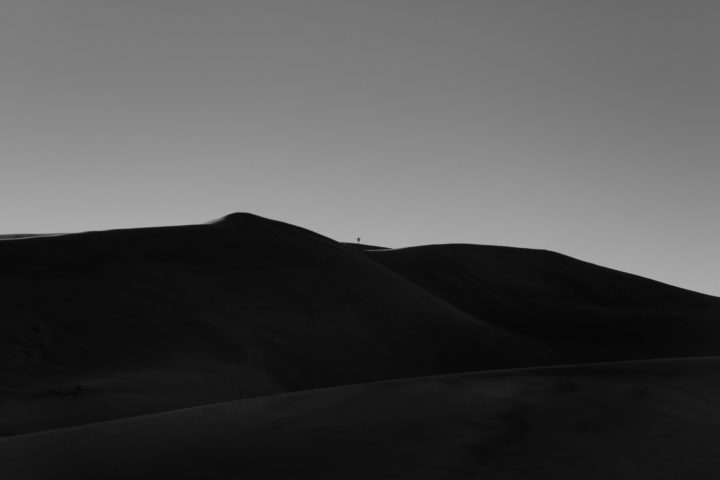 Man Jumping Off Sand Dune