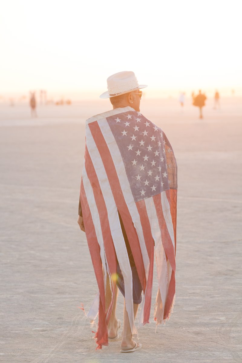 Burner Wearing Tattered American Flag