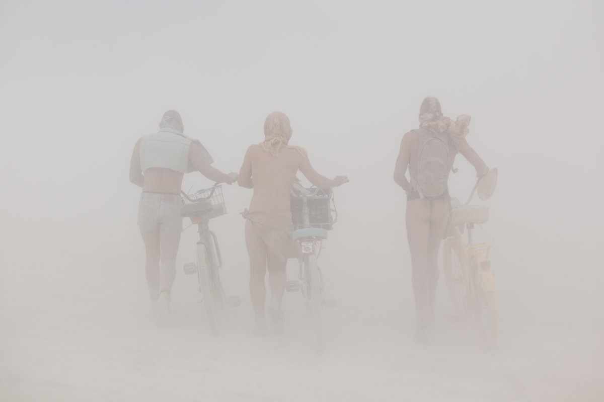 Burners Walking Their Bikes In A Whiteout