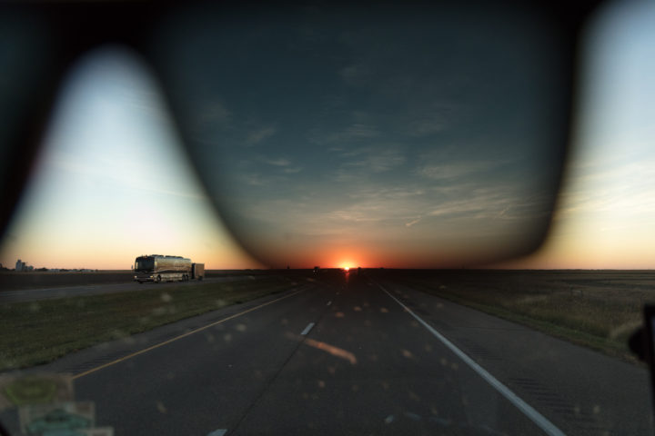Tour Bus And Sunglasses At Sunrise