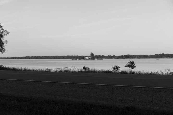 Person Sitting On Bench Alone
