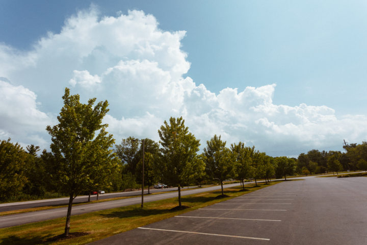 Clouds Trees And Parking Lot