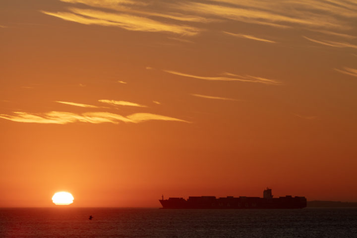 Sunset And Cargo Ship