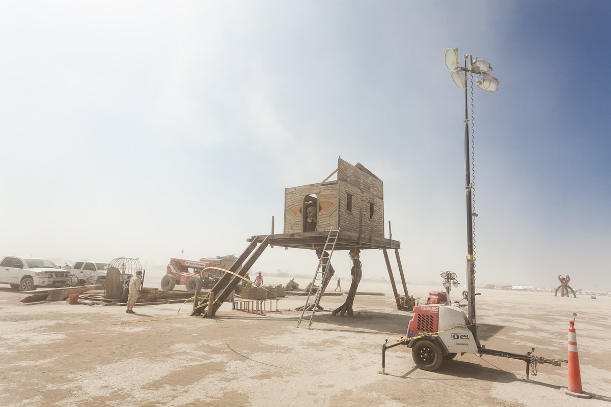 Baba Yaga's House by: Jessi Sprocket Janusee and Baba Yaga's Book Club from: Reno, NV year: 2018 The house of Baba Yaga will rise from the playa straddling it's mechanical chicken legs. The crone's house will be poised to run at the slightest provocation. Ascend her staircases to test the old witch if you dare. Are you able to walk through the veil of mortality into the space where the seer dwells? If you are strong of will, feeling bold and willing to show vulnerability she may allow you to venture within her sanctum. URL: http://jessisprocket.com/baba-yaga/