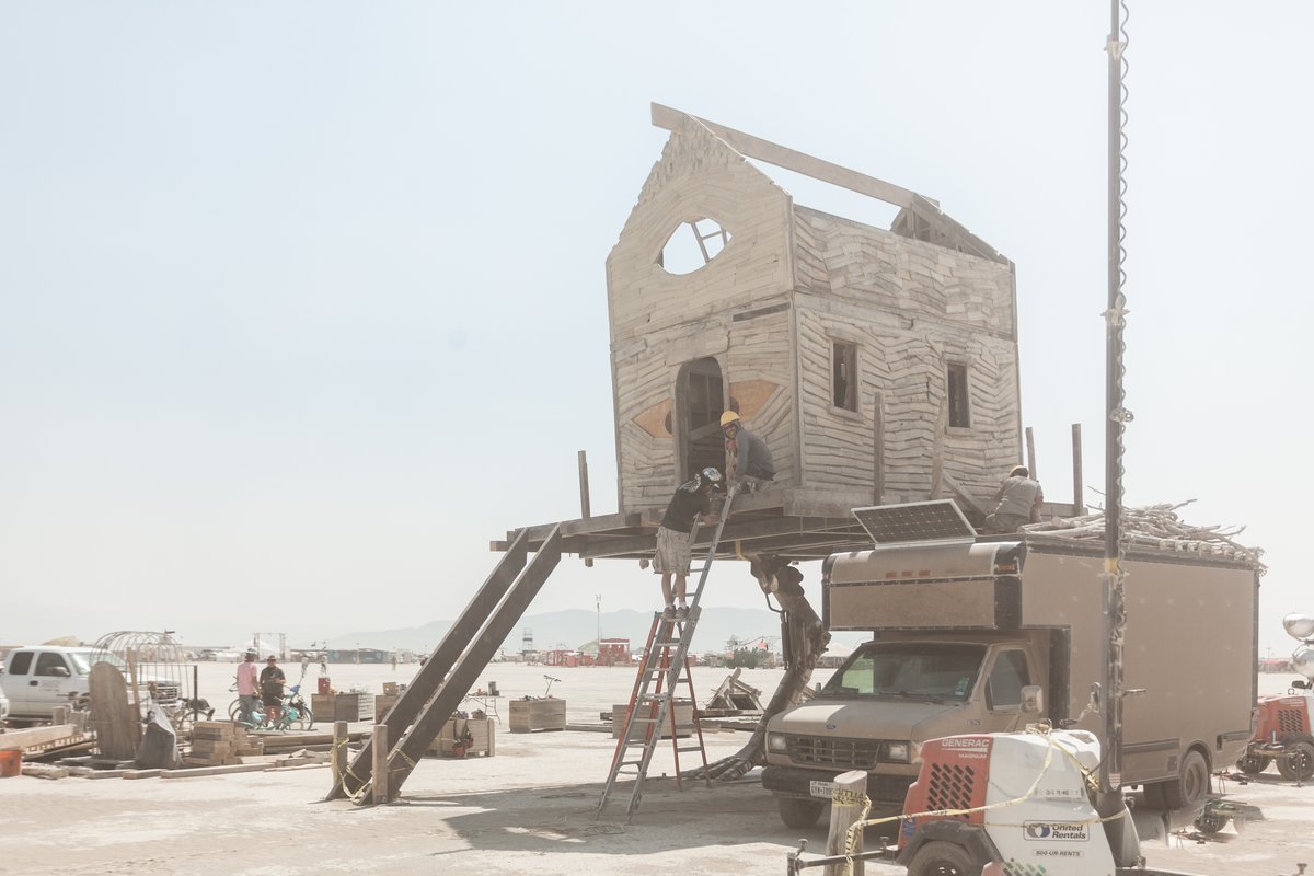 Baba Yaga's House by: Jessi Sprocket Janusee and Baba Yaga's Book Club from: Reno, NV year: 2018 The house of Baba Yaga will rise from the playa straddling it's mechanical chicken legs. The crone's house will be poised to run at the slightest provocation. Ascend her staircases to test the old witch if you dare. Are you able to walk through the veil of mortality into the space where the seer dwells? If you are strong of will, feeling bold and willing to show vulnerability she may allow you to venture within her sanctum. URL: http://jessisprocket.com/baba-yaga/