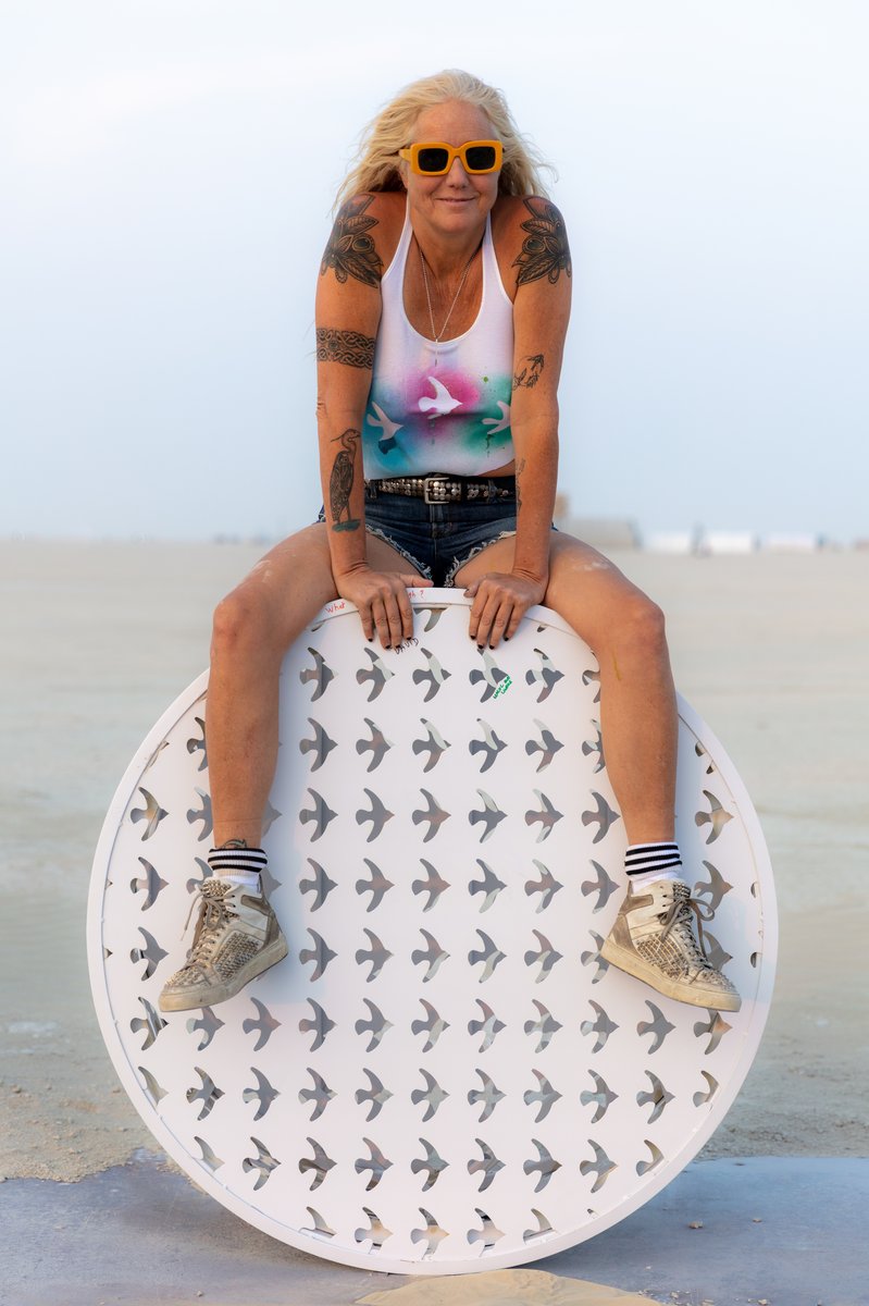 Sitting on a . from her piece: HaHa... (When your art matches your shirt. Next level!)