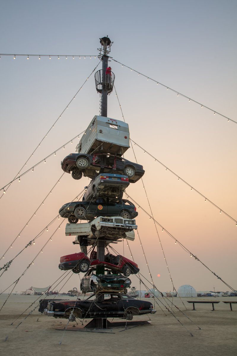 Night at the Climb In by: Dustin Weatherford from: Reno, NV year: 2018 Night at the Climb In will be a 70 foot tall stack of reclaimed junkyard cars, stacked straight up, one on top of the next. Every car will be climbable, visitable, interactive in its own way. The stack will end in a crows nest that sits at the top of the structure, just under a large spinning lit up sign. URL: https://www.facebook.com/nightattheclimbin/