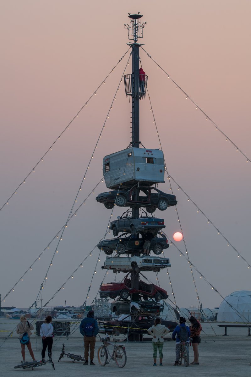 Night at the Climb In by: Dustin Weatherford from: Reno, NV year: 2018 Night at the Climb In will be a 70 foot tall stack of reclaimed junkyard cars, stacked straight up, one on top of the next. Every car will be climbable, visitable, interactive in its own way. The stack will end in a crows nest that sits at the top of the structure, just under a large spinning lit up sign. URL: https://www.facebook.com/nightattheclimbin/