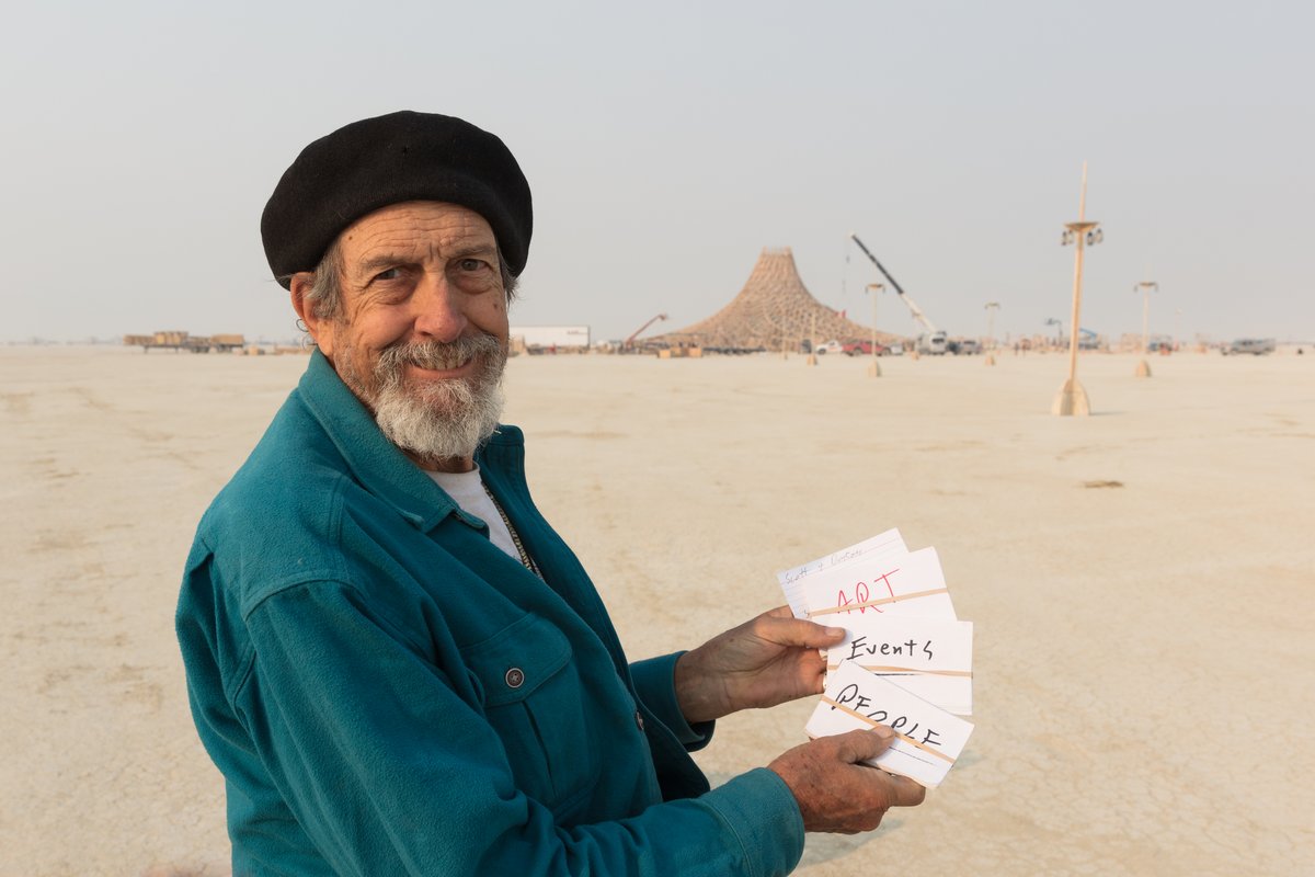 George is an amazing photographer. He has been shooting Burning Man for ages. In this photograph George is showing me his system for organizing Burning Man information while he is on playa. I asked him to show me when I told he where we we're camped and he quickly noted it. So simple and effective. Someone tells you something, and you just jot it down on an individual card. Then you can reshuffle later and discard as needed etc. I will steal this idea. Thanks George!