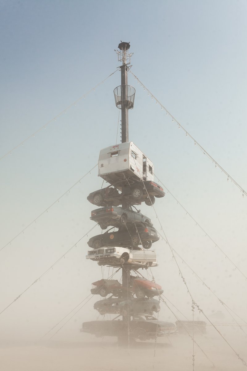 Night at the Climb In by: Dustin Weatherford from: Reno, NV year: 2018 Night at the Climb In will be a 70 foot tall stack of reclaimed junkyard cars, stacked straight up, one on top of the next. Every car will be climbable, visitable, interactive in its own way. The stack will end in a crows nest that sits at the top of the structure, just under a large spinning lit up sign. URL: https://www.facebook.com/nightattheclimbin/