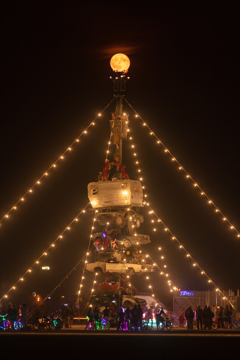 Night at the Climb In by: Dustin Weatherford from: Reno, NV year: 2018 Night at the Climb In will be a 70 foot tall stack of reclaimed junkyard cars, stacked straight up, one on top of the next. Every car will be climbable, visitable, interactive in its own way. The stack will end in a crows nest that sits at the top of the structure, just under a large spinning lit up sign. URL: https://www.facebook.com/nightattheclimbin/