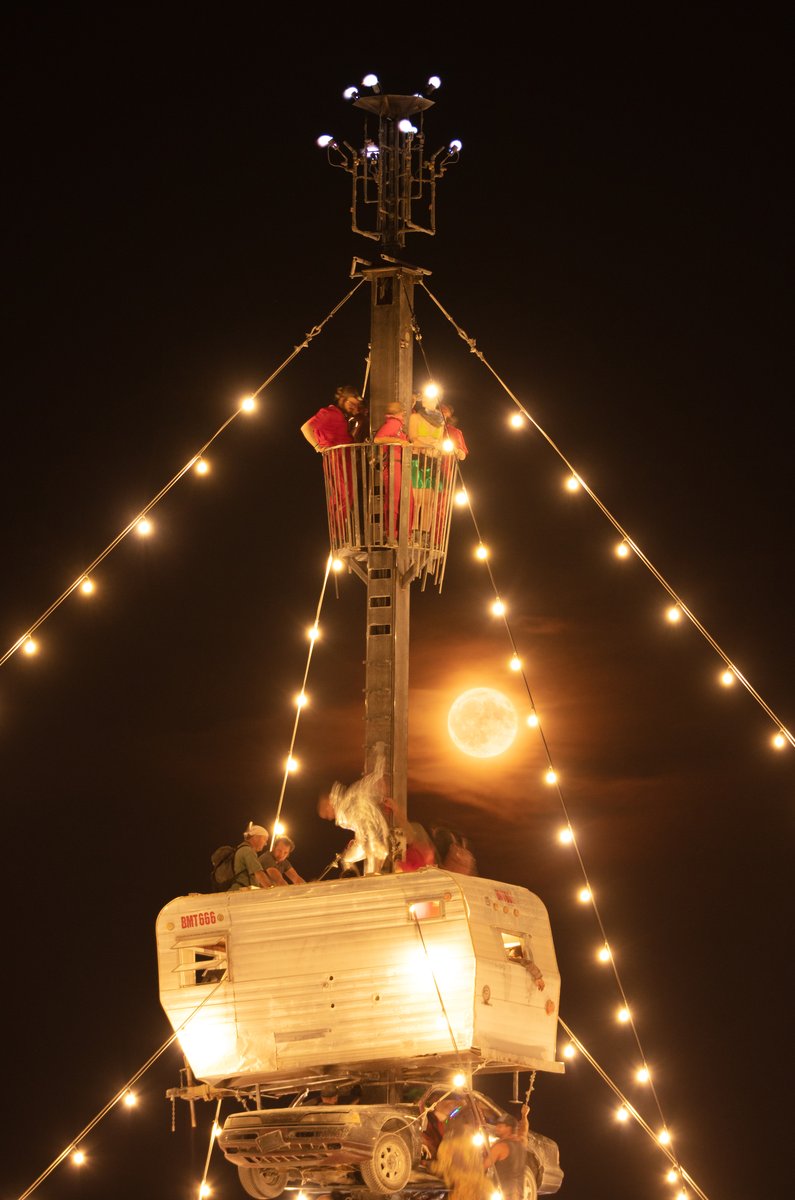 Night at the Climb In by: Dustin Weatherford from: Reno, NV year: 2018 Night at the Climb In will be a 70 foot tall stack of reclaimed junkyard cars, stacked straight up, one on top of the next. Every car will be climbable, visitable, interactive in its own way. The stack will end in a crows nest that sits at the top of the structure, just under a large spinning lit up sign. URL: https://www.facebook.com/nightattheclimbin/