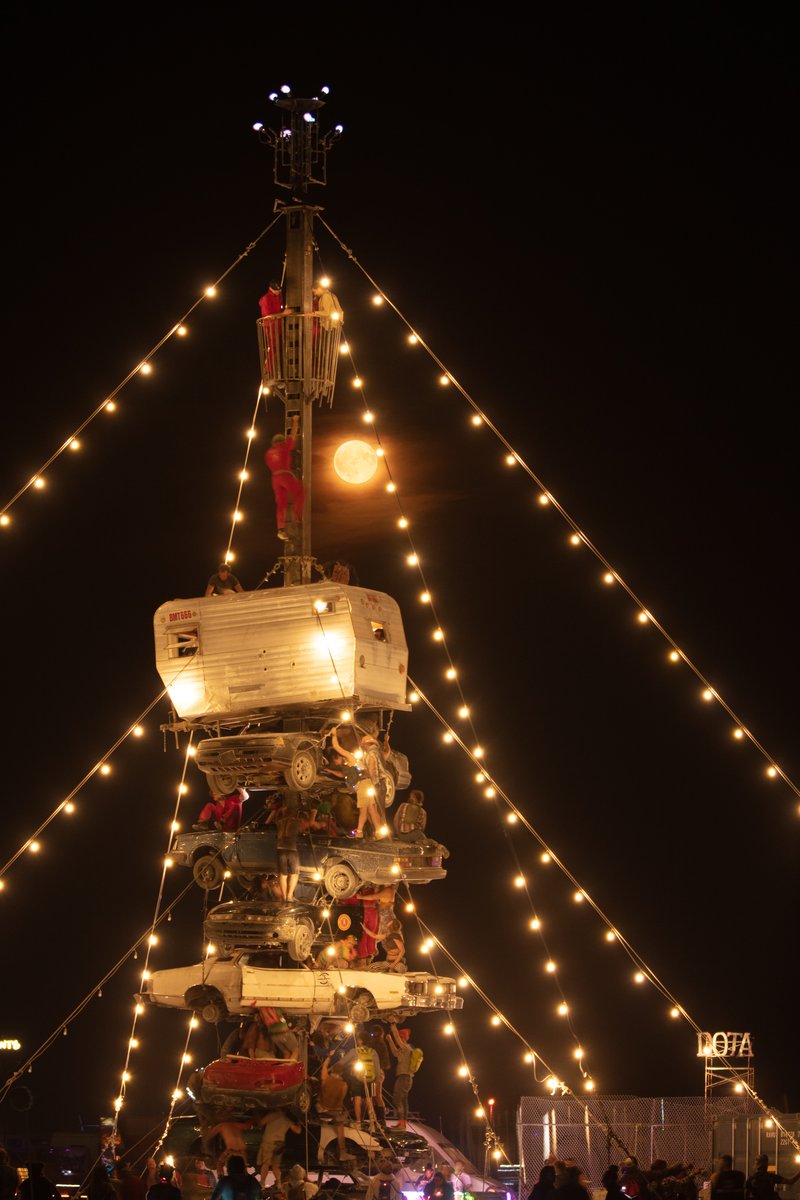 Night at the Climb In by: Dustin Weatherford from: Reno, NV year: 2018 Night at the Climb In will be a 70 foot tall stack of reclaimed junkyard cars, stacked straight up, one on top of the next. Every car will be climbable, visitable, interactive in its own way. The stack will end in a crows nest that sits at the top of the structure, just under a large spinning lit up sign. URL: https://www.facebook.com/nightattheclimbin/