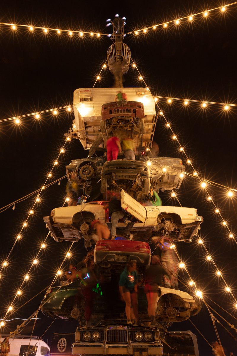 Night at the Climb In by: Dustin Weatherford from: Reno, NV year: 2018 Night at the Climb In will be a 70 foot tall stack of reclaimed junkyard cars, stacked straight up, one on top of the next. Every car will be climbable, visitable, interactive in its own way. The stack will end in a crows nest that sits at the top of the structure, just under a large spinning lit up sign. URL: https://www.facebook.com/nightattheclimbin/