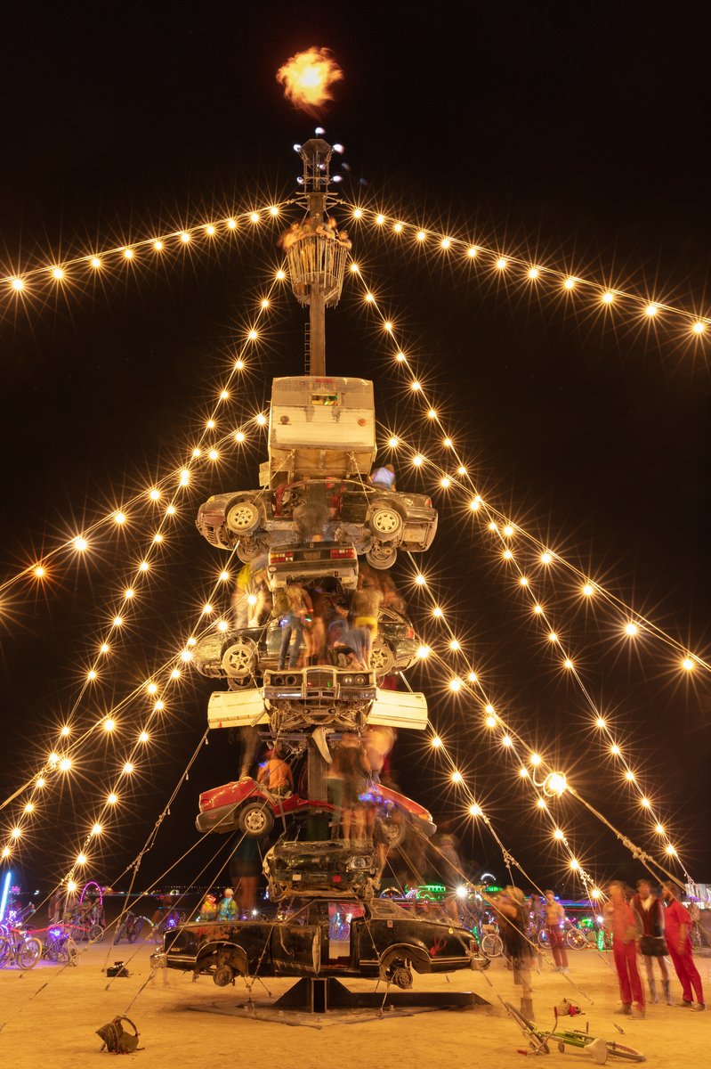 Night at the Climb In by: Dustin Weatherford from: Reno, NV year: 2018 Night at the Climb In will be a 70 foot tall stack of reclaimed junkyard cars, stacked straight up, one on top of the next. Every car will be climbable, visitable, interactive in its own way. The stack will end in a crows nest that sits at the top of the structure, just under a large spinning lit up sign. URL: https://www.facebook.com/nightattheclimbin/