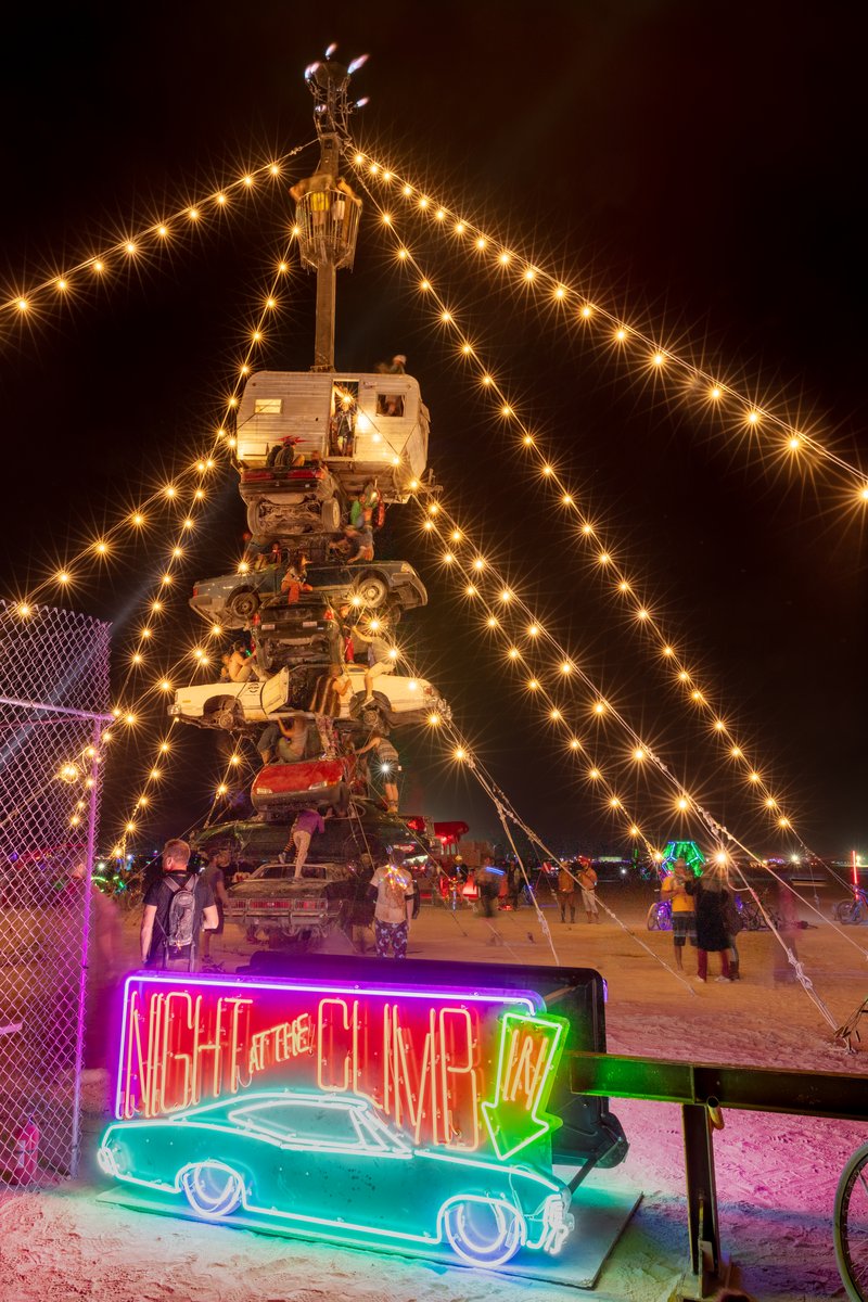 Night at the Climb In by: Dustin Weatherford from: Reno, NV year: 2018 Night at the Climb In will be a 70 foot tall stack of reclaimed junkyard cars, stacked straight up, one on top of the next. Every car will be climbable, visitable, interactive in its own way. The stack will end in a crows nest that sits at the top of the structure, just under a large spinning lit up sign. URL: https://www.facebook.com/nightattheclimbin/
