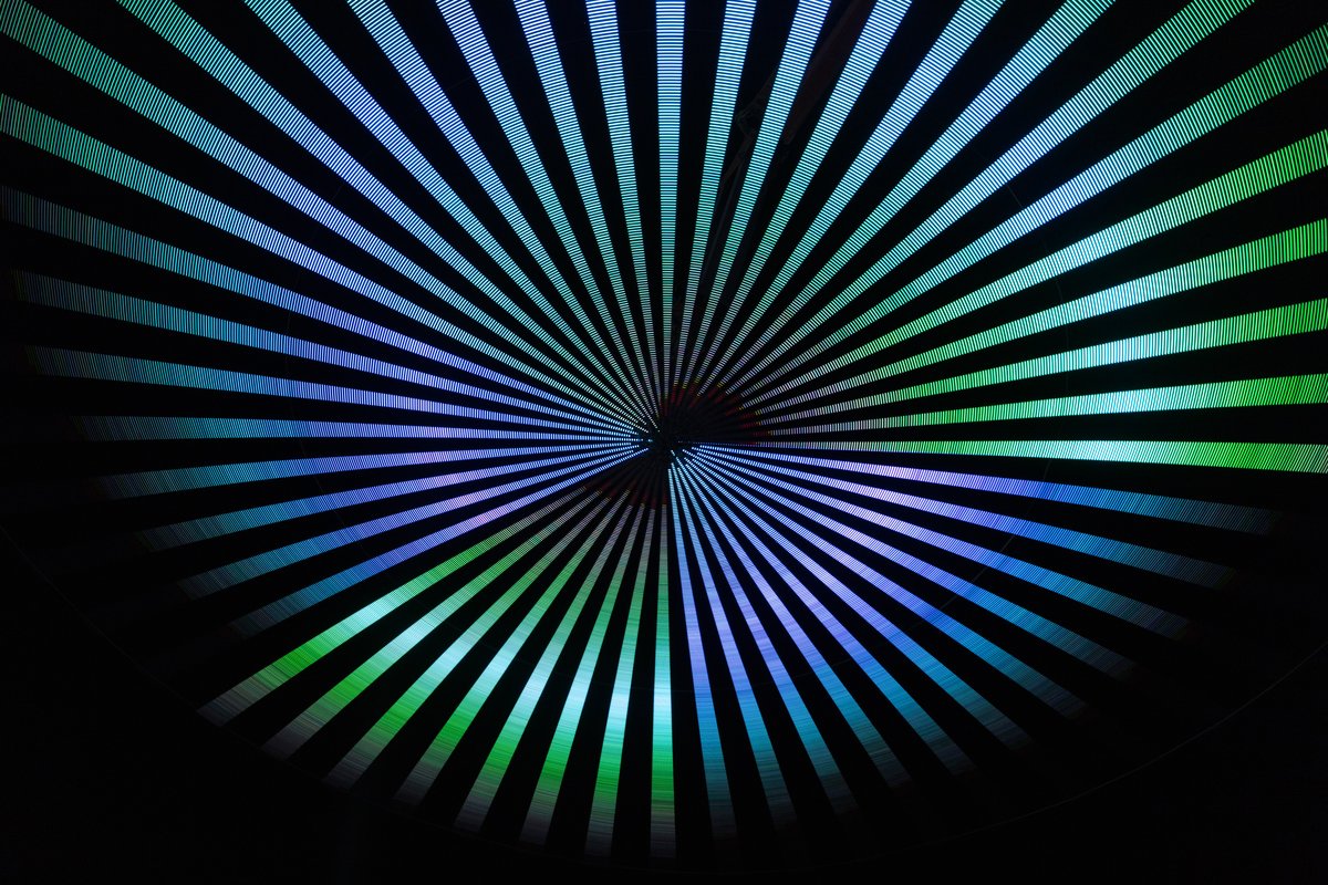 Paraluna by: Christopher Schardt from: Oakland, CA year: 2018 Paraluna combines kinetic sculpture, LEDs and music. Its main component is a disc 10m in diameter with 17,280 LEDs. A computer controls the LEDs while rotating, raising, lowering, and tilting the disc. Some of the LED patterns work with the rotation of the disk, creating spirals. Others use persistence-of-vision, making an image hover in space above the spinning LEDs. Spokes demonstrates both of these styles: https://photos.app.goo.gl/DcP9IauNTjRHENUh2 Surrounding the disc are several high-quality speakers that play classical music at comfortable, yet immersive volume, creating a comfortable, peaceful place to be. Patterns are chosen to complement each musical piece, as with Firmament: https://photos.app.goo.gl/H6KCzkf5jkGWAA3m2
