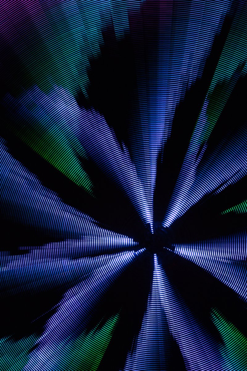 Paraluna by: Christopher Schardt from: Oakland, CA year: 2018 Paraluna combines kinetic sculpture, LEDs and music. Its main component is a disc 10m in diameter with 17,280 LEDs. A computer controls the LEDs while rotating, raising, lowering, and tilting the disc. Some of the LED patterns work with the rotation of the disk, creating spirals. Others use persistence-of-vision, making an image hover in space above the spinning LEDs. Spokes demonstrates both of these styles: https://photos.app.goo.gl/DcP9IauNTjRHENUh2 Surrounding the disc are several high-quality speakers that play classical music at comfortable, yet immersive volume, creating a comfortable, peaceful place to be. Patterns are chosen to complement each musical piece, as with Firmament: https://photos.app.goo.gl/H6KCzkf5jkGWAA3m2