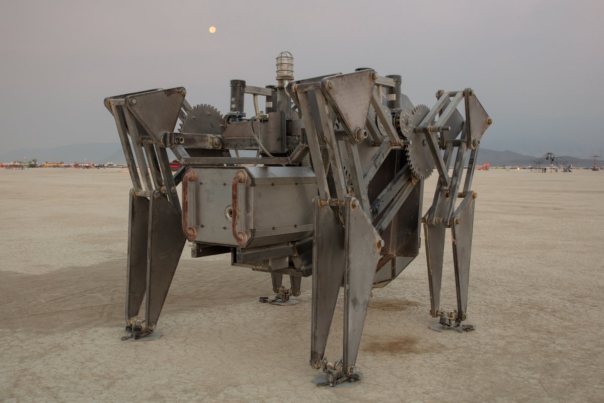 QuadruPOD by: Scott Parenteau (the Tinman) from: Sacramento, CA year: 2018 I'm calling this machine the QuadruPOD simply because its a Pod with 4 legs. It's a variation of a Strandbeest and uses a modified version of Theo Jensens leg linkage. This will allow the pod to walk around the playa during the daylight hours creating an art piece that actually looks for you. This pod will be an all metal walking machine with a steam punk appearance, lots of rust and plenty of moving gears. An operator will ride inside this machine during its performances on the playa but it will be designed to operate robotically as well.