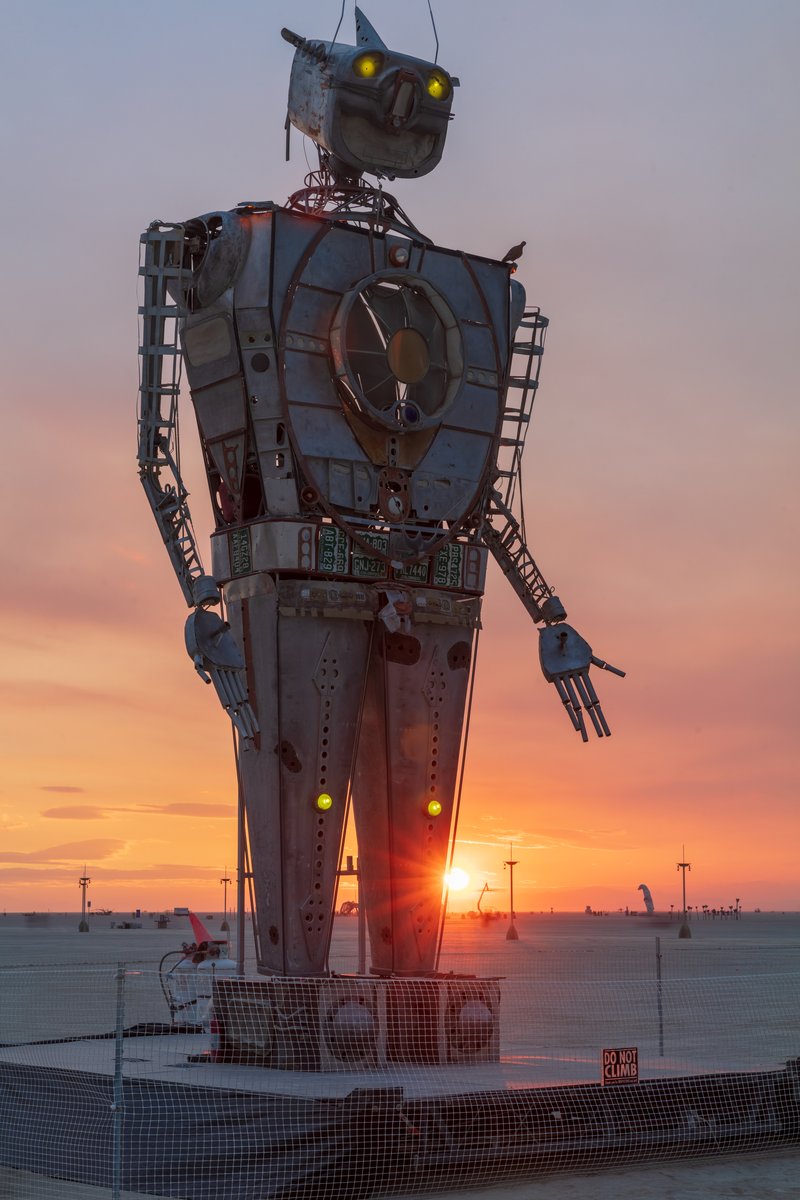 Robot Resurrection by: Shane Evans from: Denver, CO year: 2018 Robot Resurrection is towering 30 foot tall, human piloted, articulating sculpture made from reclaimed airplane parts and found objects. From the torso cockpit, the operator(s) manipulate the Robot's motions and fire effects. This piece is a representation of we all have become... Robots. It is a wake-up call of how large these problems are. We have been controlled for too long. Robot Resurrection was born from what we as a society have discarded. Our hope is that this 28′ Robot will inspire reflection upon one's self and be a reminder of the power we all hold. We hope it awakens some awareness of our situation and encourages some small change on a small scale that leads to big change in the massive system.