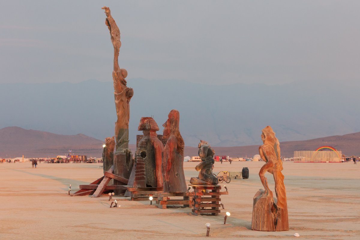 Artifactual Intelligence by: Timeless and the Guardians from: Carson City, NV year: 2018 A trail of wooden sculptures range from large to huge, all leading toward The Temple. A numbered posting at each describes the evolution of "Fire Inside", about the art form born on-playa a decade past, born from arson on Liberty itself, now playa folklore ... about how these enigmatic, backward fires now produce massive playa artifacts, the only known to survive their own burn... How the burning style, a whisper of the playa itself has become powerful ritual that transforms earth, wind, fire and water into enduring talismen charged with their own mission of liberation and renewal. But can such artifacts guard and guide us to a positive AI singularity? Learn why they can and how they will -- with Artifactual Intelligence... URL: https://www.fireinsideart.com/burning-man-project-2018