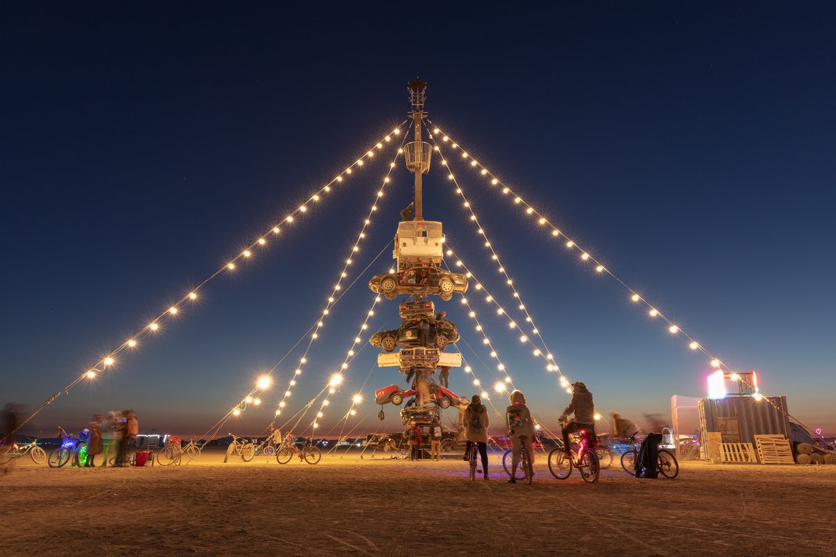 Night at the Climb In by: Dustin Weatherford from: Reno, NV year: 2018 Night at the Climb In will be a 70 foot tall stack of reclaimed junkyard cars, stacked straight up, one on top of the next. Every car will be climbable, visitable, interactive in its own way. The stack will end in a crows nest that sits at the top of the structure, just under a large spinning lit up sign. URL: https://www.facebook.com/nightattheclimbin/