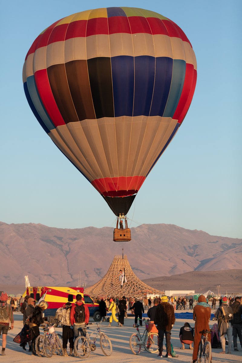 Strait No Chaser : The Great Strait Escape by: LadyBEAST and GatorDox from: Oakland, CA year: 2018 Strait No Chaser : The Great Strait Escape is a performance art installation in which Arianna (LadyBEAST) will be secured in a strait jacket and suspended by her feet from the basket of a hot air balloon. The piece is supported by a team from GatorDox camp. It is a radical expression of internal and external struggles gracefully suspended in a chaotic world.