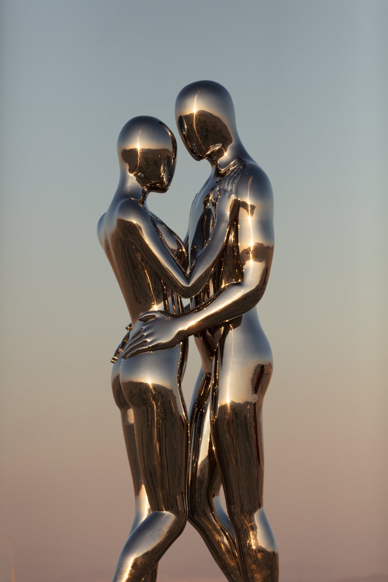 In Every Lifetime I Will Find You by: Michael Benisty, Love and Unity from: Brooklyn, NY year: 2018 A sculptural representation of Male and Female holding one another in a symbolic and universal position of caring in a display of Love and Unity. Measuring 25 feet tall and made out of mirror polished stainless steel.
