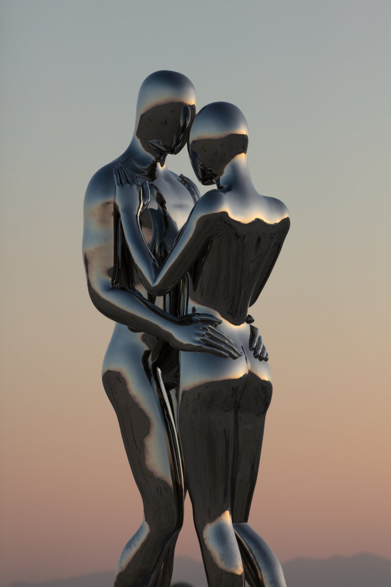 In Every Lifetime I Will Find You by: Michael Benisty, Love and Unity from: Brooklyn, NY year: 2018 A sculptural representation of Male and Female holding one another in a symbolic and universal position of caring in a display of Love and Unity. Measuring 25 feet tall and made out of mirror polished stainless steel.