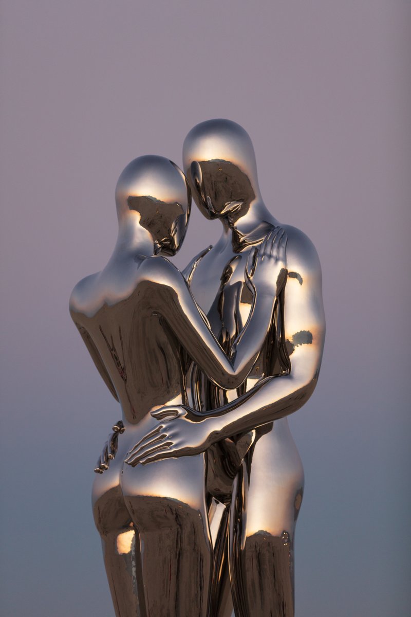In Every Lifetime I Will Find You by: Michael Benisty, Love and Unity from: Brooklyn, NY year: 2018 A sculptural representation of Male and Female holding one another in a symbolic and universal position of caring in a display of Love and Unity. Measuring 25 feet tall and made out of mirror polished stainless steel.