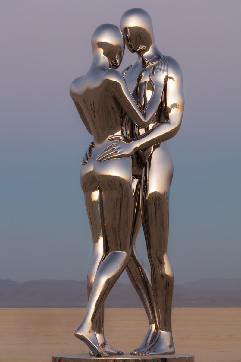 In Every Lifetime I Will Find You by: Michael Benisty, Love and Unity from: Brooklyn, NY year: 2018 A sculptural representation of Male and Female holding one another in a symbolic and universal position of caring in a display of Love and Unity. Measuring 25 feet tall and made out of mirror polished stainless steel.
