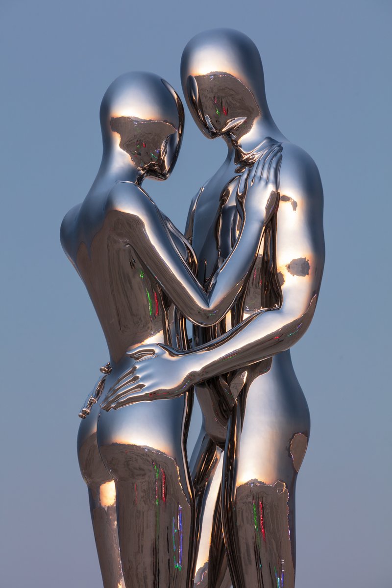In Every Lifetime I Will Find You by: Michael Benisty, Love and Unity from: Brooklyn, NY year: 2018 A sculptural representation of Male and Female holding one another in a symbolic and universal position of caring in a display of Love and Unity. Measuring 25 feet tall and made out of mirror polished stainless steel.