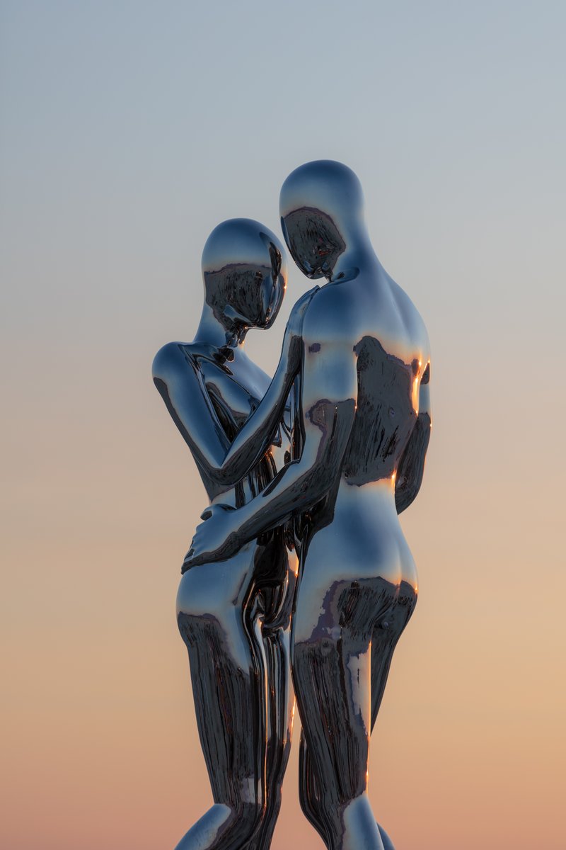 In Every Lifetime I Will Find You by: Michael Benisty, Love and Unity from: Brooklyn, NY year: 2018 A sculptural representation of Male and Female holding one another in a symbolic and universal position of caring in a display of Love and Unity. Measuring 25 feet tall and made out of mirror polished stainless steel.