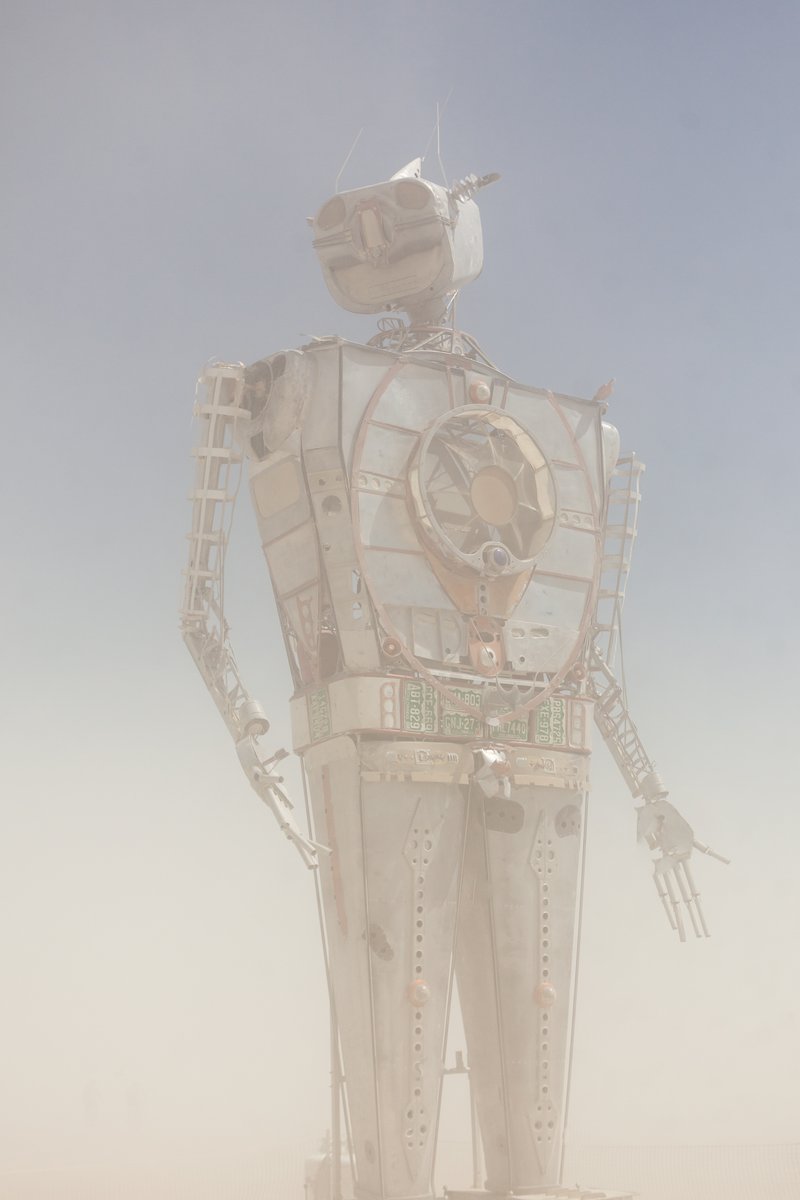 Robot Resurrection by: Shane Evans from: Denver, CO year: 2018 Robot Resurrection is towering 30 foot tall, human piloted, articulating sculpture made from reclaimed airplane parts and found objects. From the torso cockpit, the operator(s) manipulate the Robot's motions and fire effects. This piece is a representation of we all have become... Robots. It is a wake-up call of how large these problems are. We have been controlled for too long. Robot Resurrection was born from what we as a society have discarded. Our hope is that this 28′ Robot will inspire reflection upon one's self and be a reminder of the power we all hold. We hope it awakens some awareness of our situation and encourages some small change on a small scale that leads to big change in the massive system.