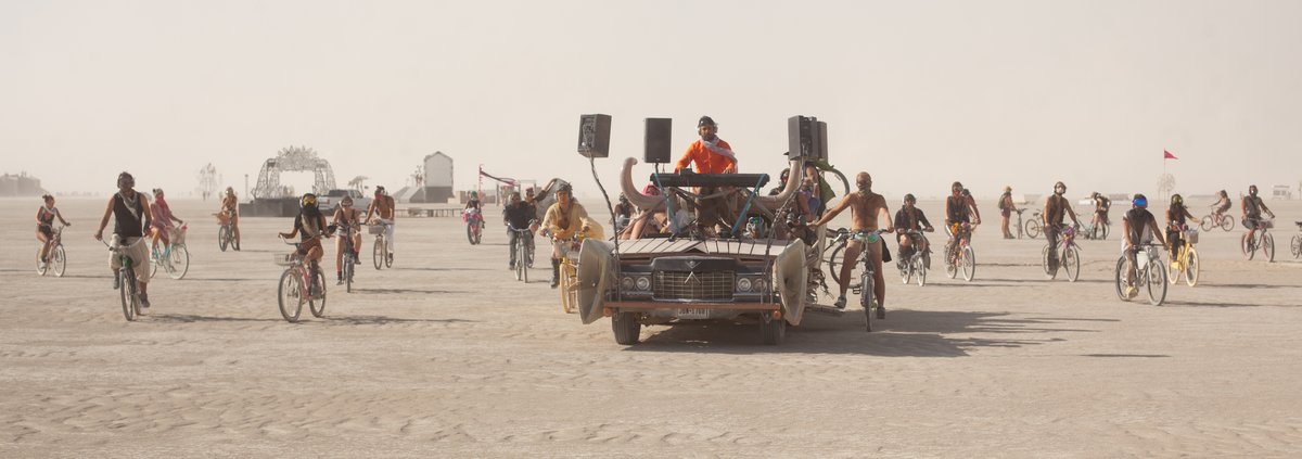I'm not sure what the name of this performance/artist is but essentially only the people wearing the wireless headphones can hear the performance as they roam around the playa. Amazing.